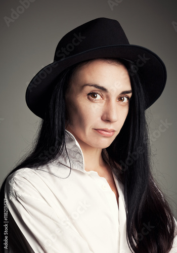 Beautiful brunette in a hat and a shirt © vladi59