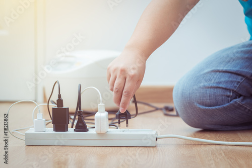 man unplugged plug to save on energy