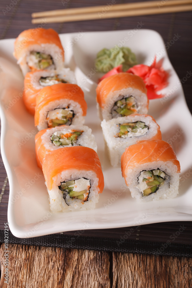 Sushi rolls Philadelphia with salmon and chopsticks close-up. Vertical
Sushi rolls Philadelphia with salmon and chopsticks close-up. Vertical