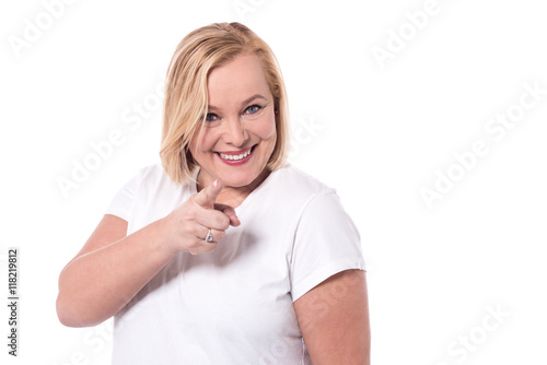 Charming woman pointing towards camera