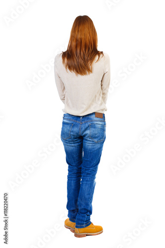 Girl carries a heavy pile of books. back view. Rear view people collection. backside view of person. Isolated over white background. Blonde in brown shoes standing back.