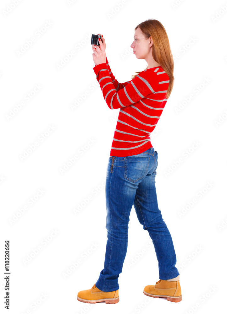 back view of standing young beautiful woman and using a mobile phone. girl watching. Rear view people collection. backside view of person. Isolated over white background. The blonde in a red back view of standing young beautiful woman and using a mobile phone. girl watching. Rear view people collection. backside view of person. Isolated over white background. The blonde in a red