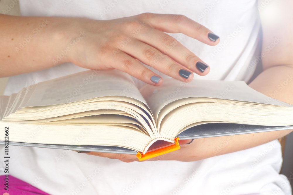 Young girl reading an open old book. Knowledge, Science. Toned image. Young girl reading an open old book. Knowledge, Science. Toned image.