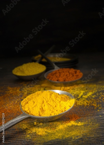 Mixed spices on a dark wooden background with copy space