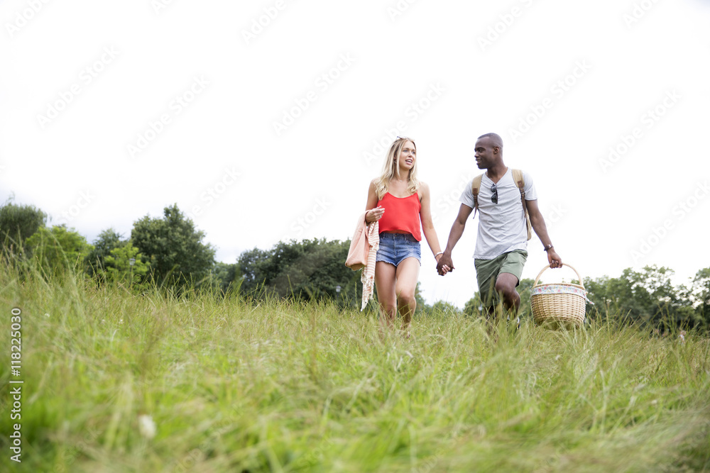 Young Couple Going For Picnic In Countryside Young Couple Going For Picnic In Countryside