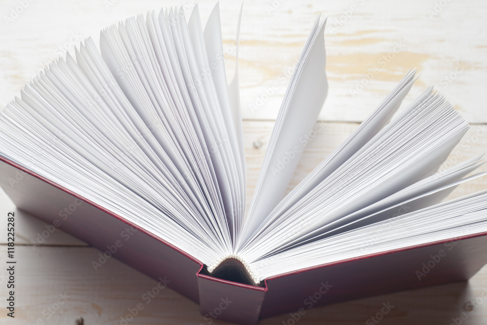 Top view of bright colorful hardback books in a circle. Open book, fanned pages. Education essential for self improvement, gaining knowledge and success in our careers, business and personal lives.