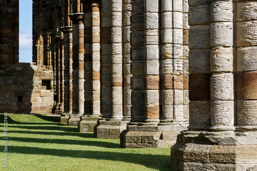 WHITBY, ENGLAND - AUGUST 12: Stone columns within the ruins of Whitby Abbey. In Whitby, North Yorkshire, England. On 12th August 2016 WHITBY, ENGLAND - AUGUST 12: Stone columns within the ruins of Whitby Abbey. In Whitby, North Yorkshire, England. On 12th August 2016