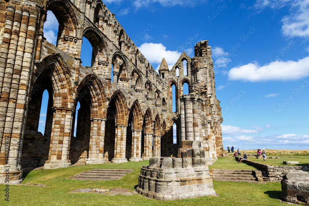 WHITBY, ENGLAND - AUGUST 12: Tourists visiting the ruins of Whitby Abbey. In Whitby, North Yorkshire, England. On 12th August 2016