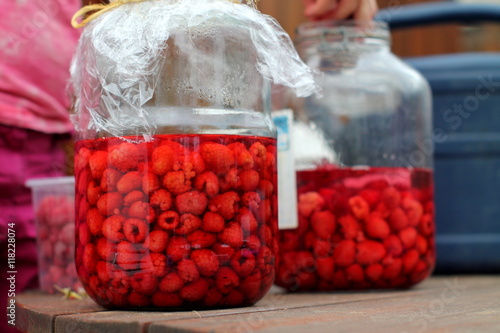 Принти на полотні Sappy ripe raspberries in glass pots spilled with juice