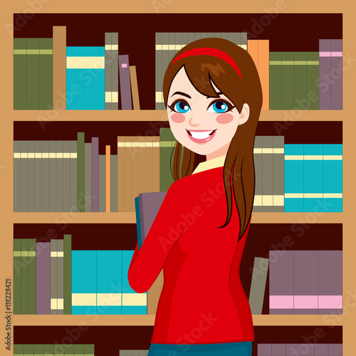 Beautiful brunette librarian woman in library holding books