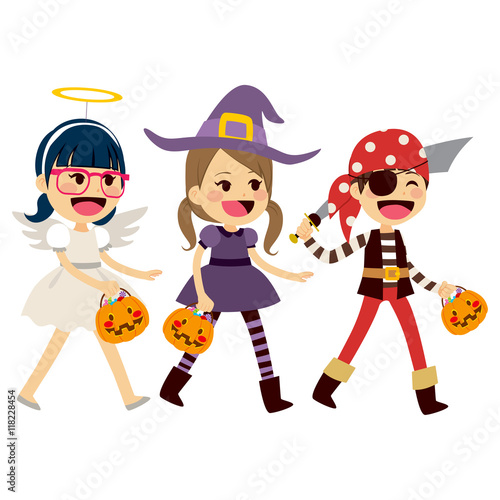 Cute little children in costumes walking for trick or treat candies on Halloween