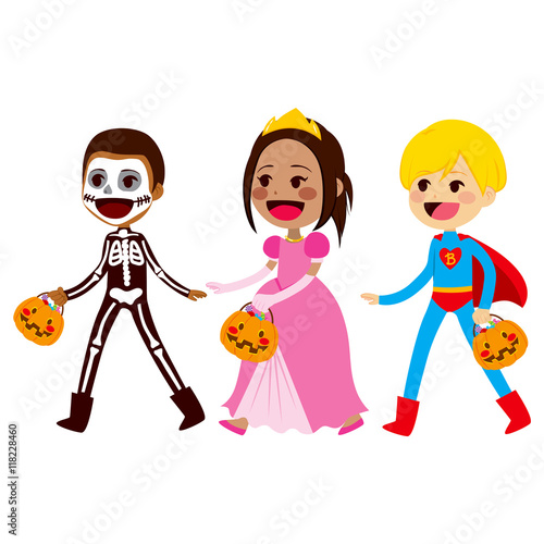 Cute little children in costumes walking for trick or treat candies on Halloween