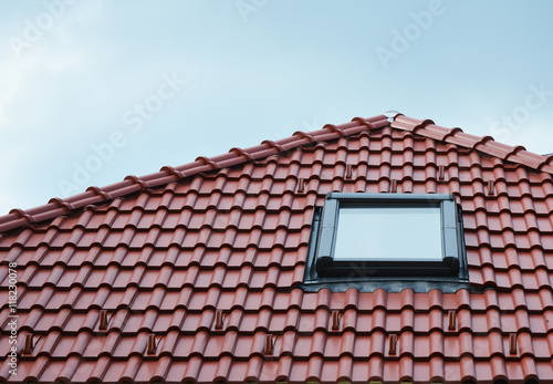 Bilde på lerret Attic skylight window on red ceramic tiles house roof outdoor