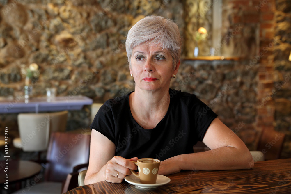 Woman in cafe drinking coffee Woman in cafe drinking coffee