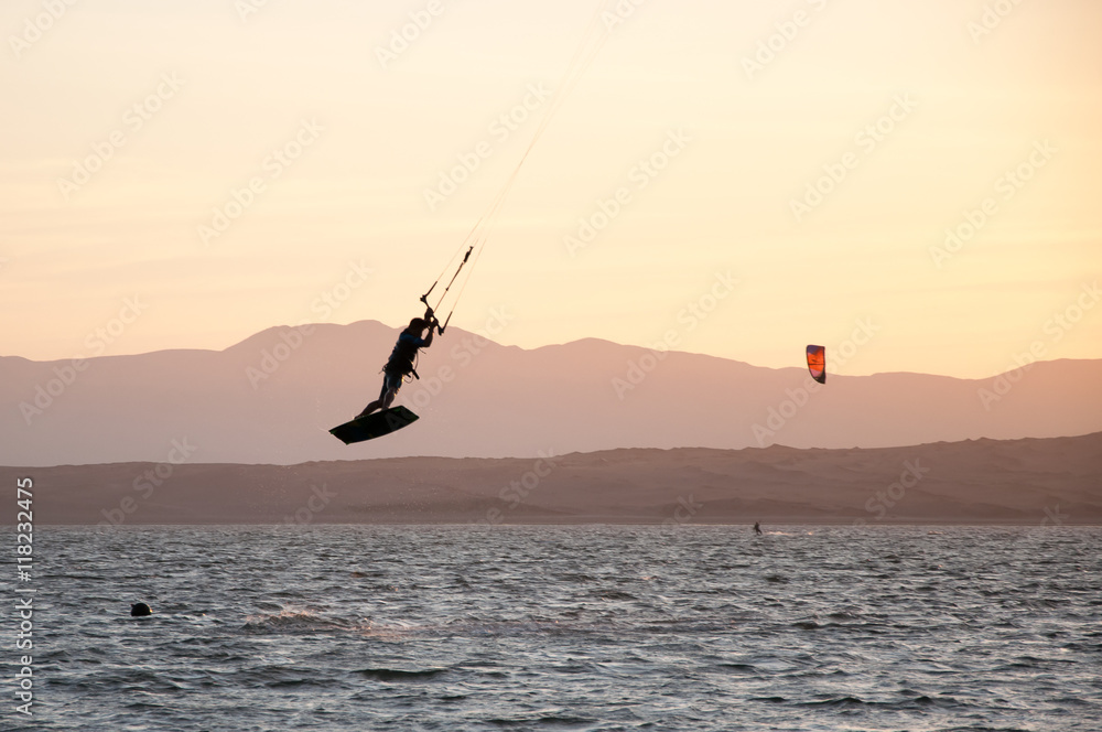 Paracas, Peru - MARCH 30, 2016:  Unidentified kitesurfer makes a trick, documentary editorial.
