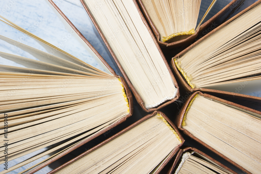 Fototapeta premium Open book, hardback books on wooden table. Back to school. Copy space for text