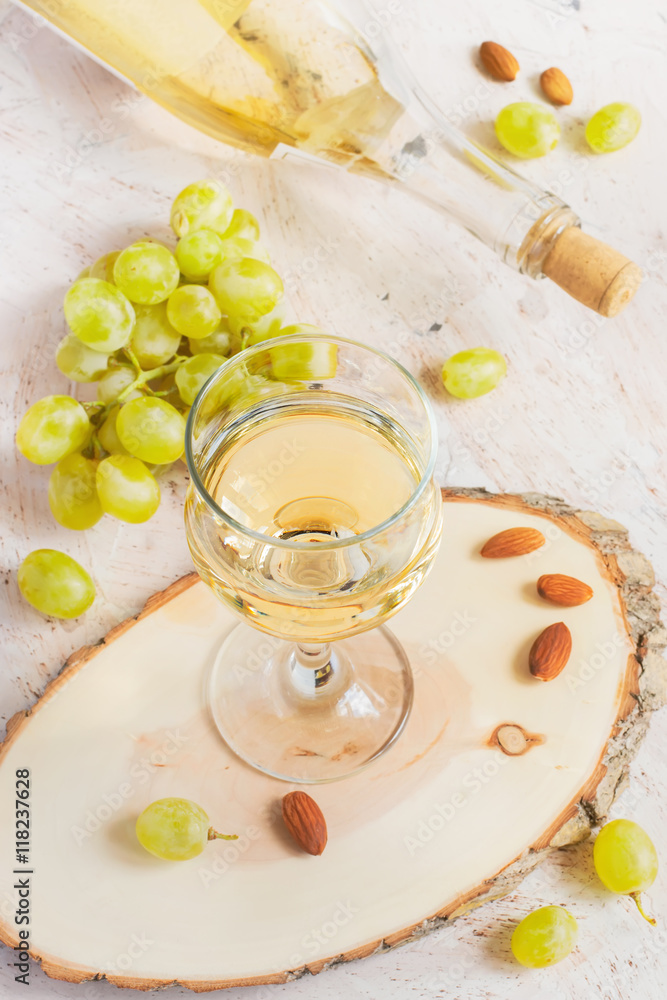 White wine in a glass and a bunch of grapes, tinted White wine in a glass and a bunch of grapes, tinted