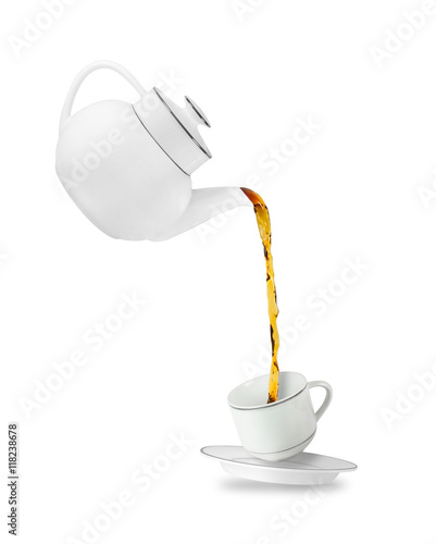 Pouring tea in tea cup. Teapot and cup isolated on white background