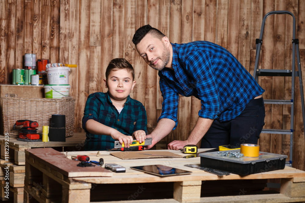 construction of father and son in the garage, family concept construction of father and son in the garage, family concept