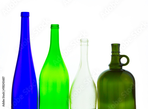 colored empty glass bottles for wine isolated on white background