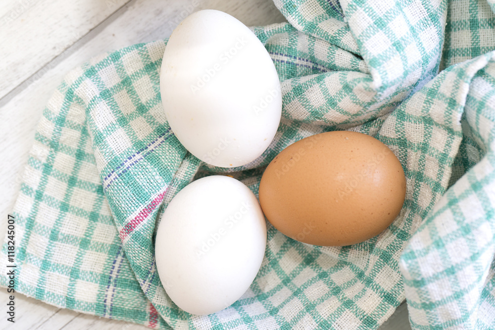 Group of three eggs on colored cloth Group of three eggs on colored cloth