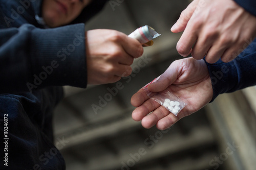 close up of addict buying dose from drug dealer photo