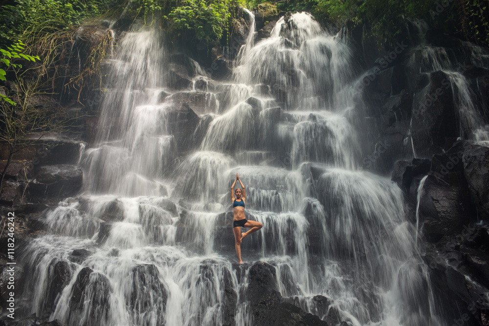 Fototapeta premium serenity and yoga practicing at waterfall Kanto Lampo, Bali,Indonesia
