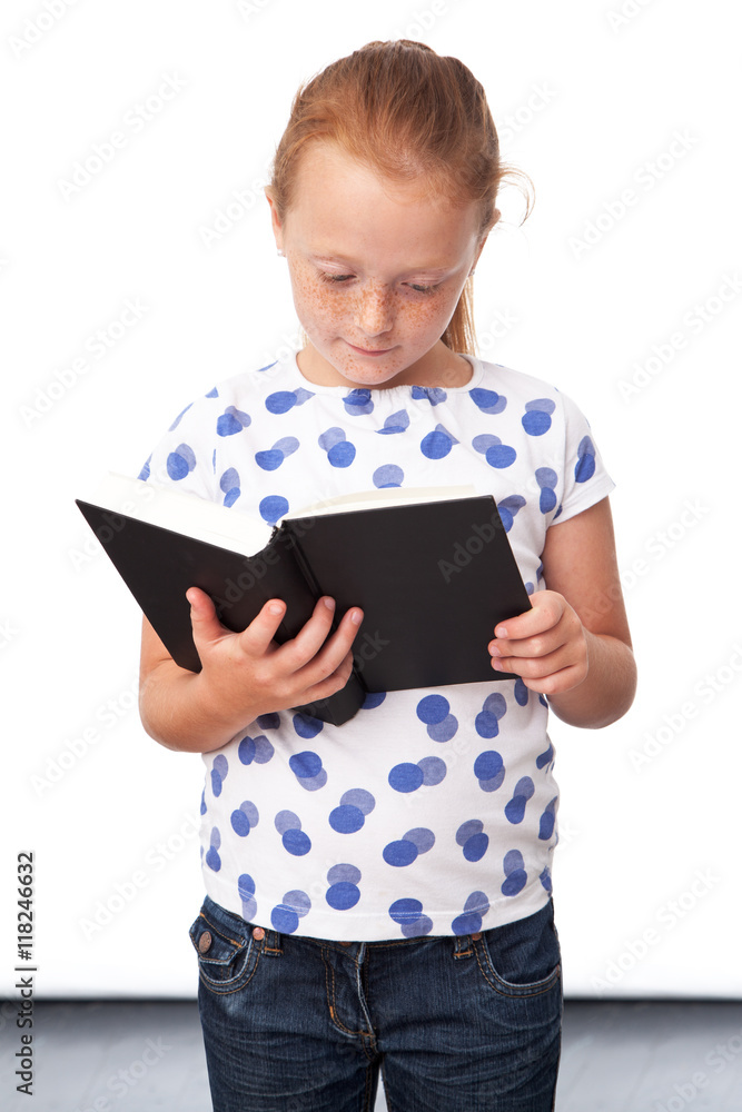 Serious ginger girl reading a book, isolated on white background Serious ginger girl reading a book, isolated on white background