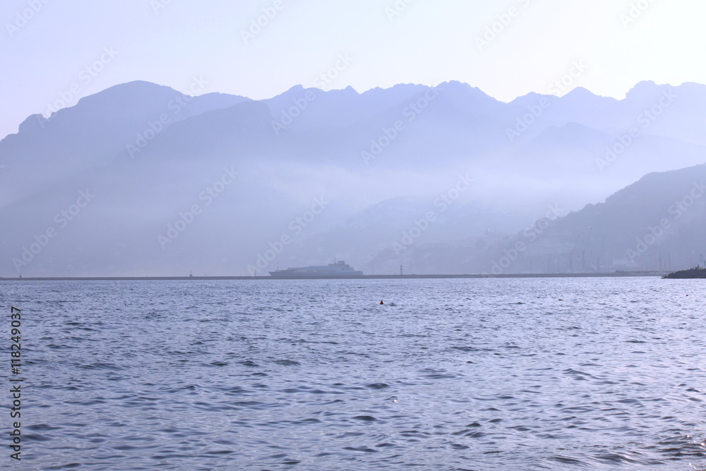 Sea coast with mountains, dock and ship in Salerno, Italy Sea coast with mountains, dock and ship in Salerno, Italy