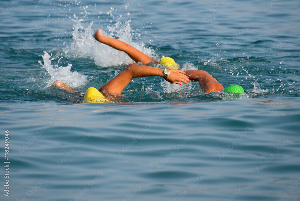 Group of swimmers swim in the sea at the races