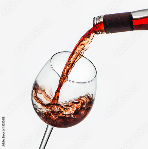 Wine being poured in glass.