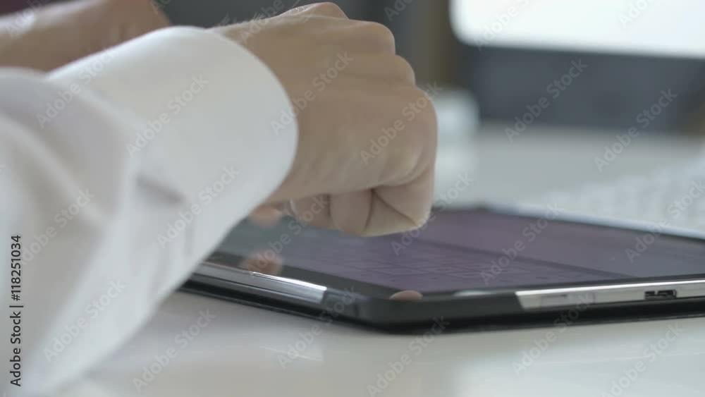 Businessman typing on a virtual keyboard on a tablet. close up with shallow depth of field Businessman typing on a virtual keyboard on a tablet. close up with shallow depth of field