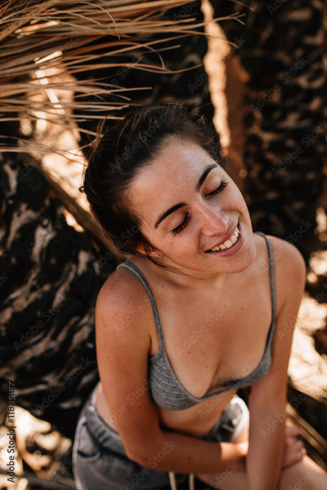 Happy brunette smiling with eyes closed Happy brunette smiling with eyes closed