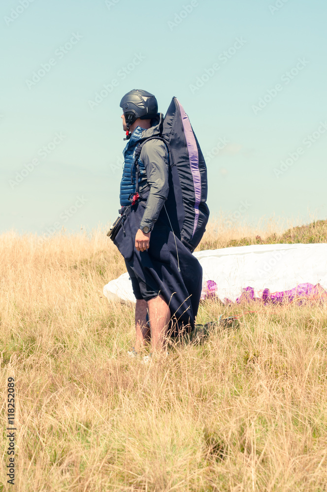 Male paraglider waiting to take off