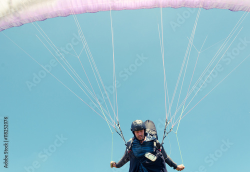 Low angle of male paraglider taking off
