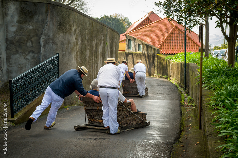 Funchal traditional sledge downhill riders in Monte park. Funchal traditional sledge downhill riders in Monte park.