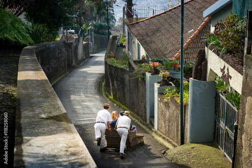 Cane sledge downhill ride on asphalt streets of Funchal.