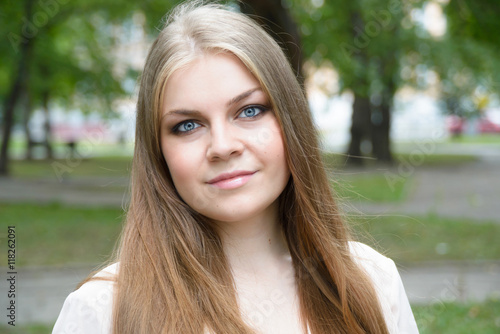 Portrait of beautiful blonde girl on the nature