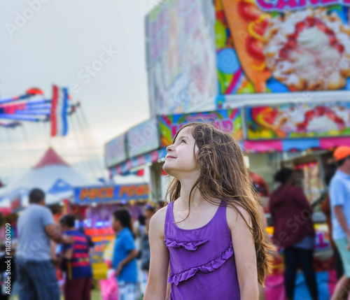 Cute girl looking over her shoulder in amusement park photo