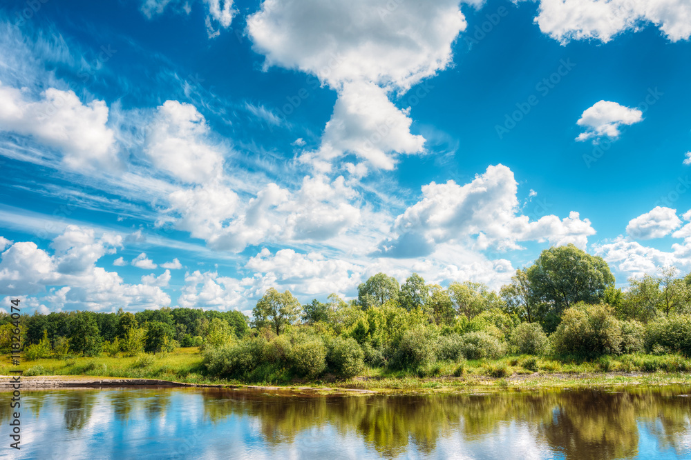 Fototapeta premium River Landscape With Reflections Of Clouds And Woods In Water.