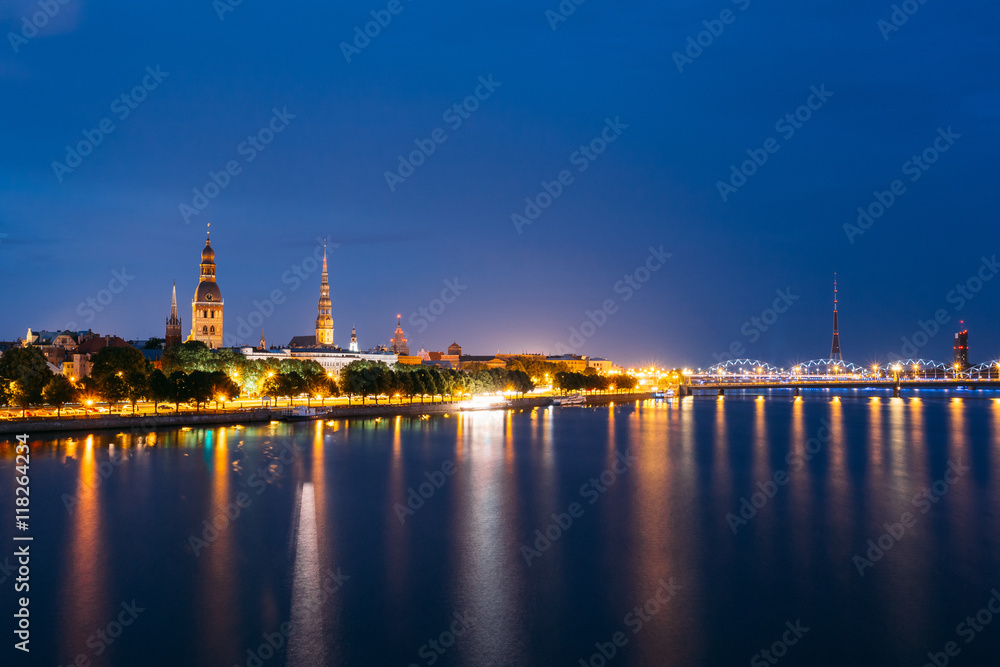 Cityscape At Evening Of Riga, Latvia. Night View With Blue Sky. 
