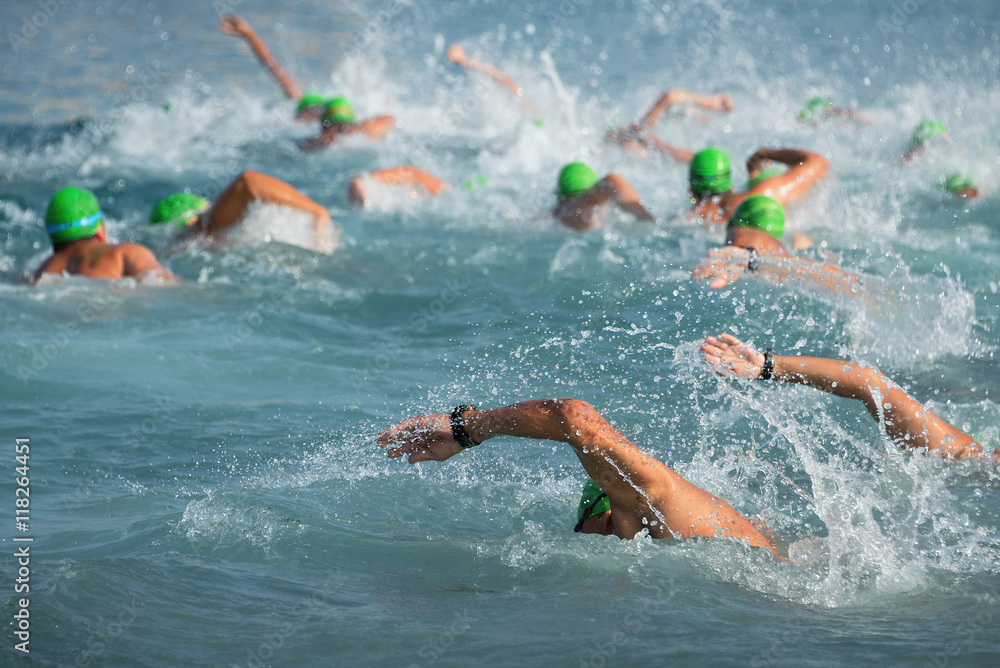 Group of swimmers swim in the sea at the races