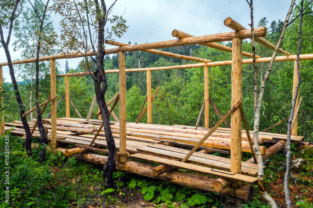 Installation of wooden beams from logs Installation of wooden beams from logs