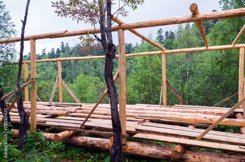 Installation of wooden beams from logs