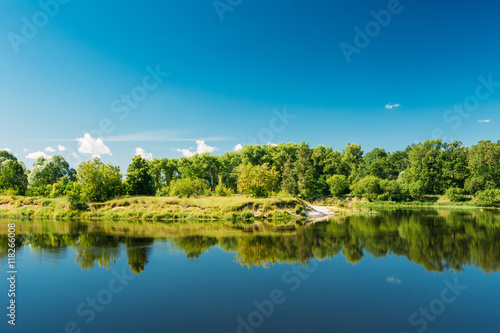 Summer River Landscape With Green Forest Woods On Coast And Reflections