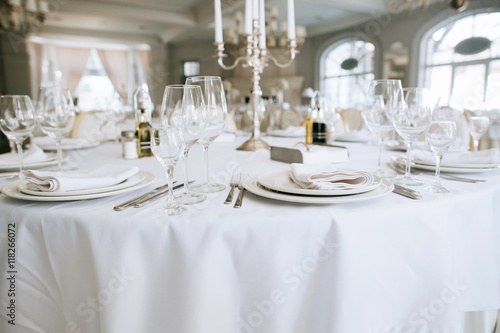 Elegant wedding reception white table arrangement restaurant,   candlestick on table © Yevhenii Kukulka