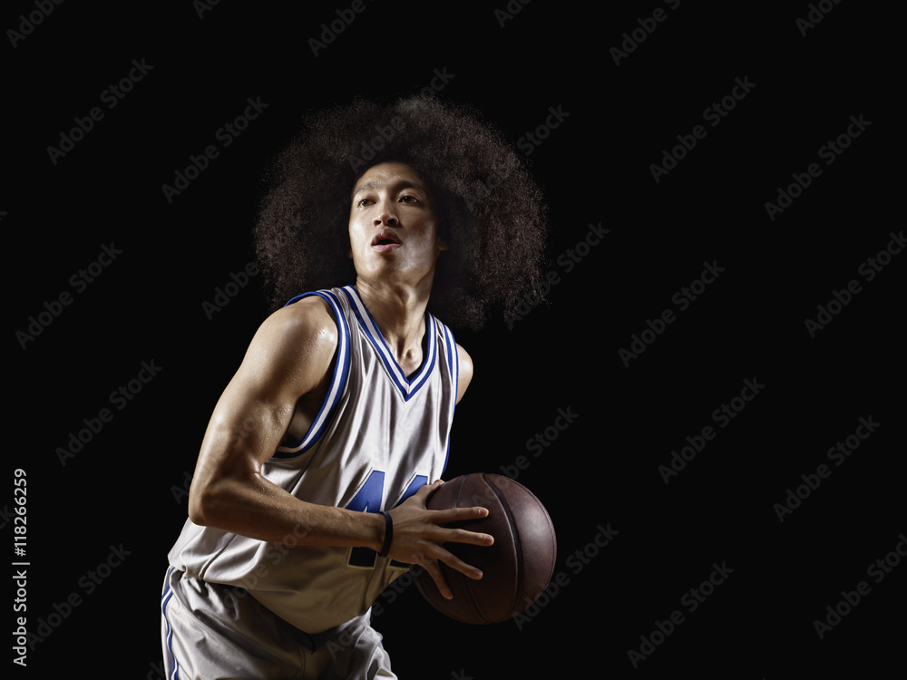 Mixed race basketball player holding basketball Mixed race basketball player holding basketball