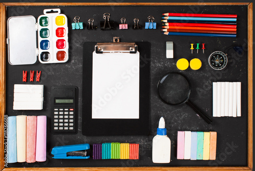 Stationery on a black background with space for text.