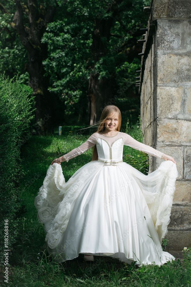 Fototapeta premium small girl in white dress outdoor