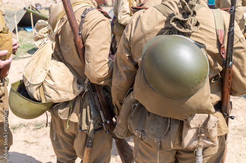 Photography two Soviet soldiers with knapsack and helmets behind